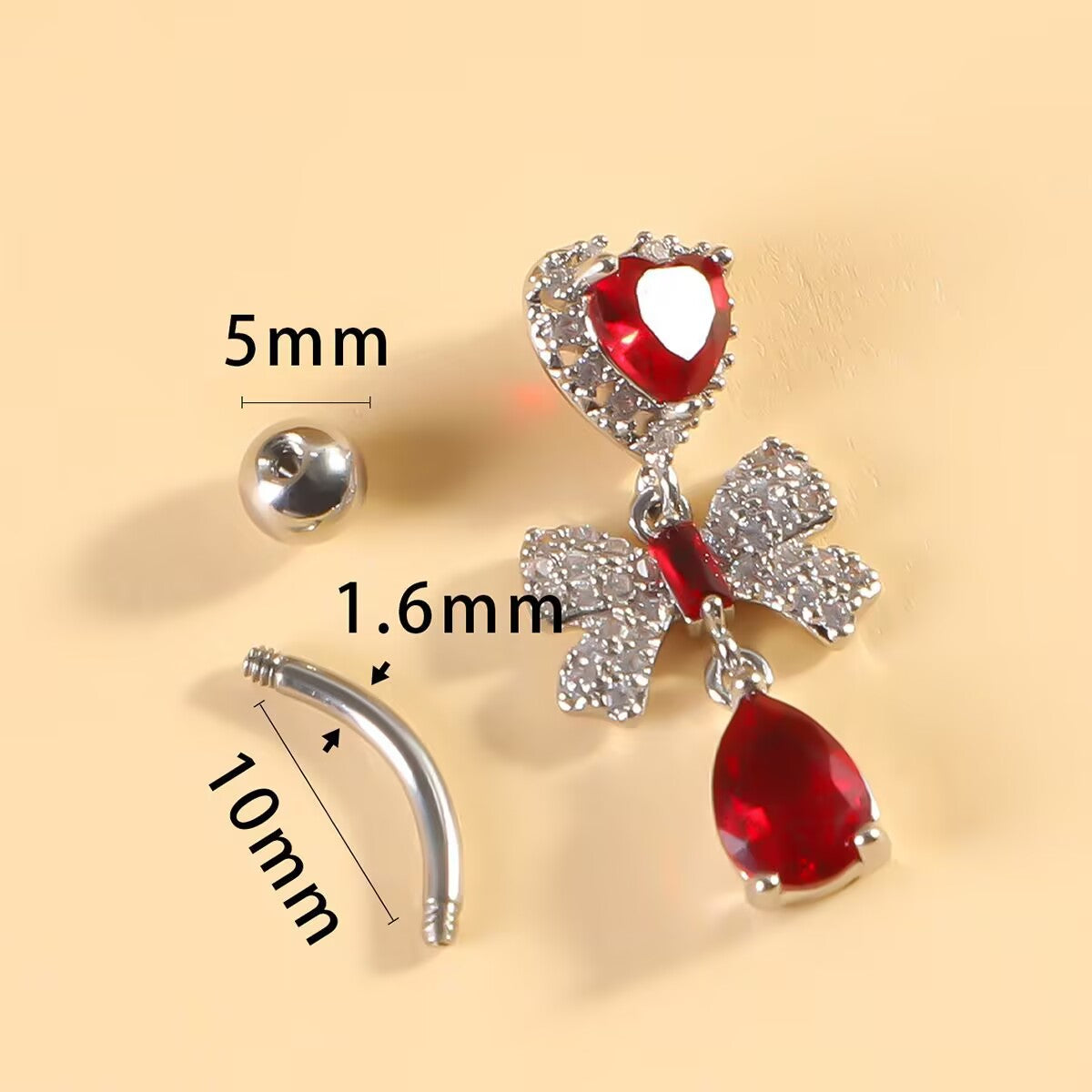 Detailed sizing diagram of a red heart and bow dangle belly ring showing 1.6mm bar gauge, 10mm bar length, and 5mm top ball.