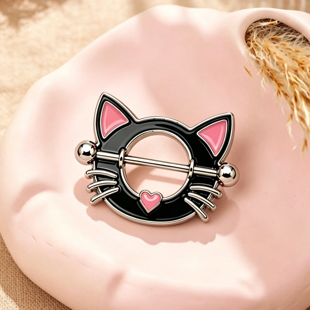 Aesthetic lifestyle shot of a black cat nipple shield on a pink decorative tray.
