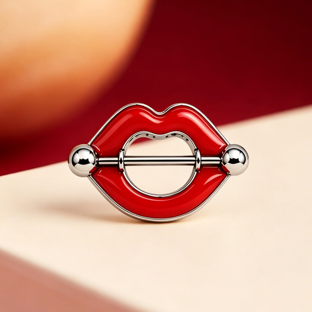 Close-up of red lips nipple jewelry displayed in a stylish aesthetic setting.