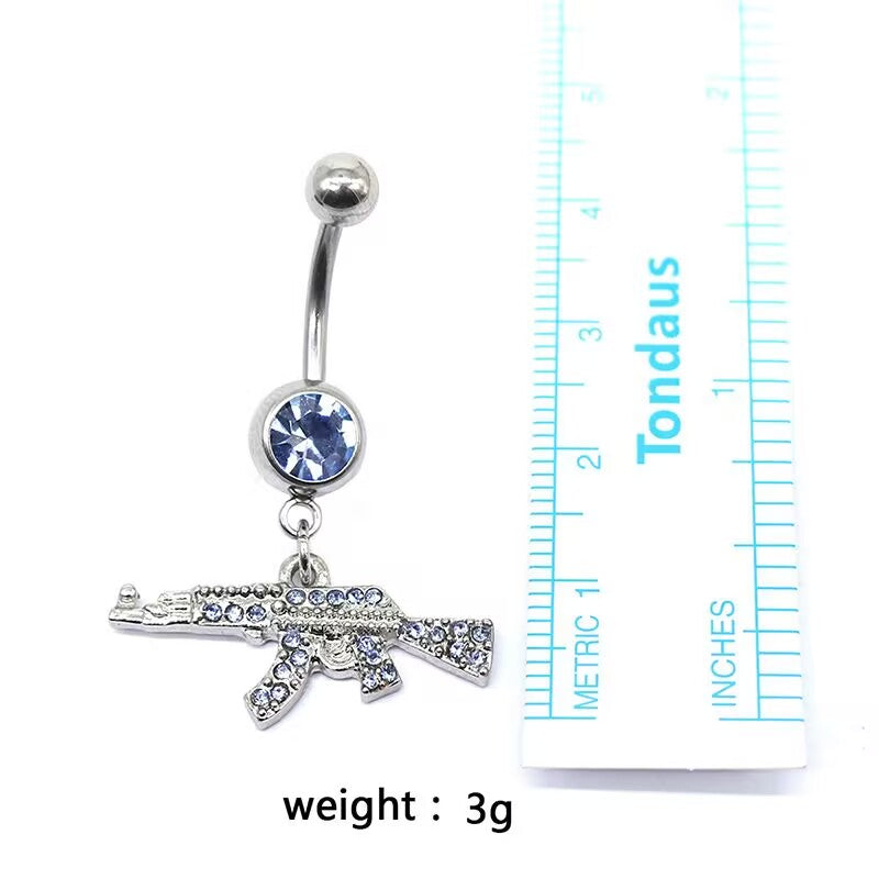 Blue rhinestone AK47 belly ring next to a measuring ruler with text showing a lightweight specifications of 3g.