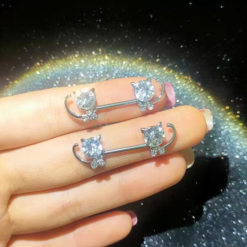 Close-up shot of shiny cat nipple rings showing a brilliant sparkle under warm lighting.