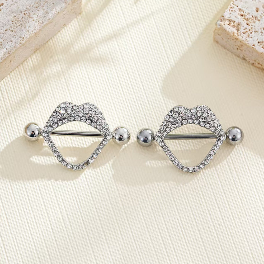 Aesthetic lifestyle shot of two clear crystal lip nipple rings.