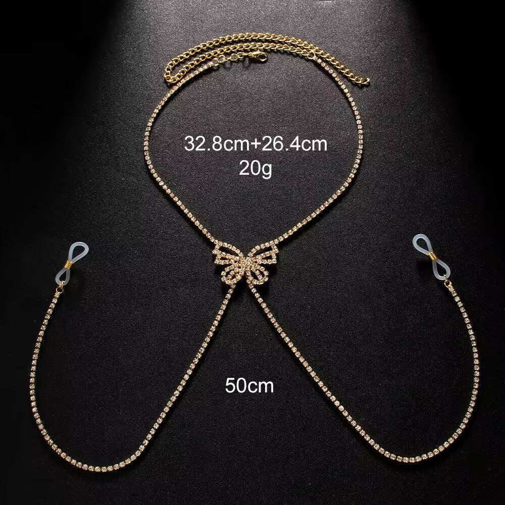 Flat lay product shot of a silver rhinestone butterfly body chain showing measurements of 32.8cm plus 26.4cm and 50cm weighing 20g.