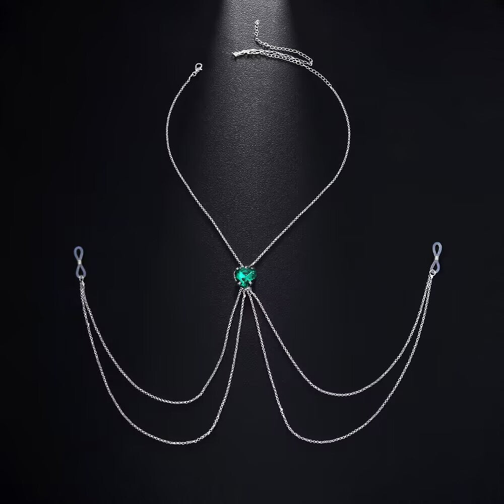 An emerald green heart crystal non-pierced nipple harness chain with flowing multi-layer silver tassels and non-slip silicone loops, displayed on a black background.