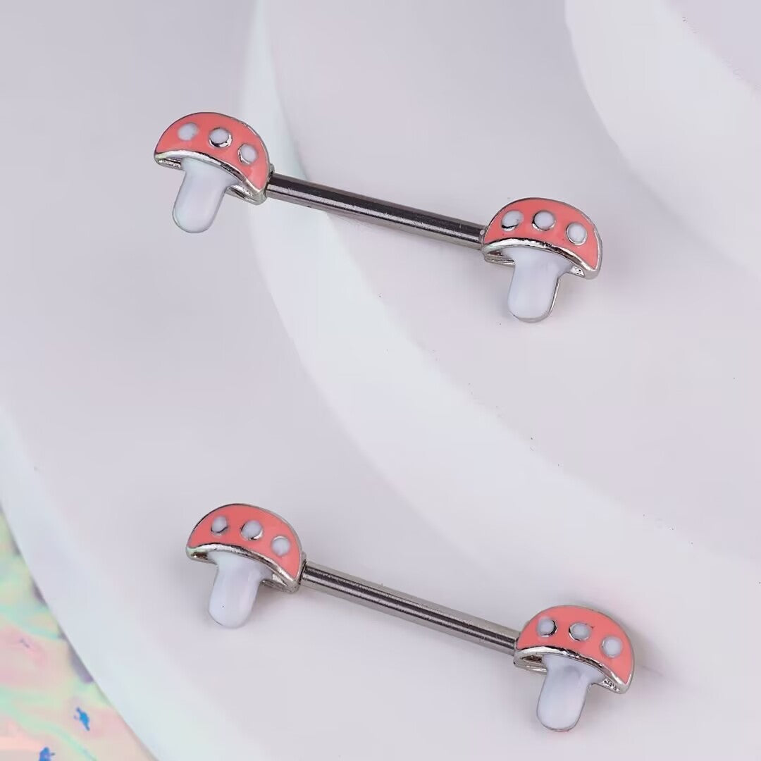 Close-up angled view of cute fairytale pink mushroom nipple barbell body jewelry presented on a clean display surface.