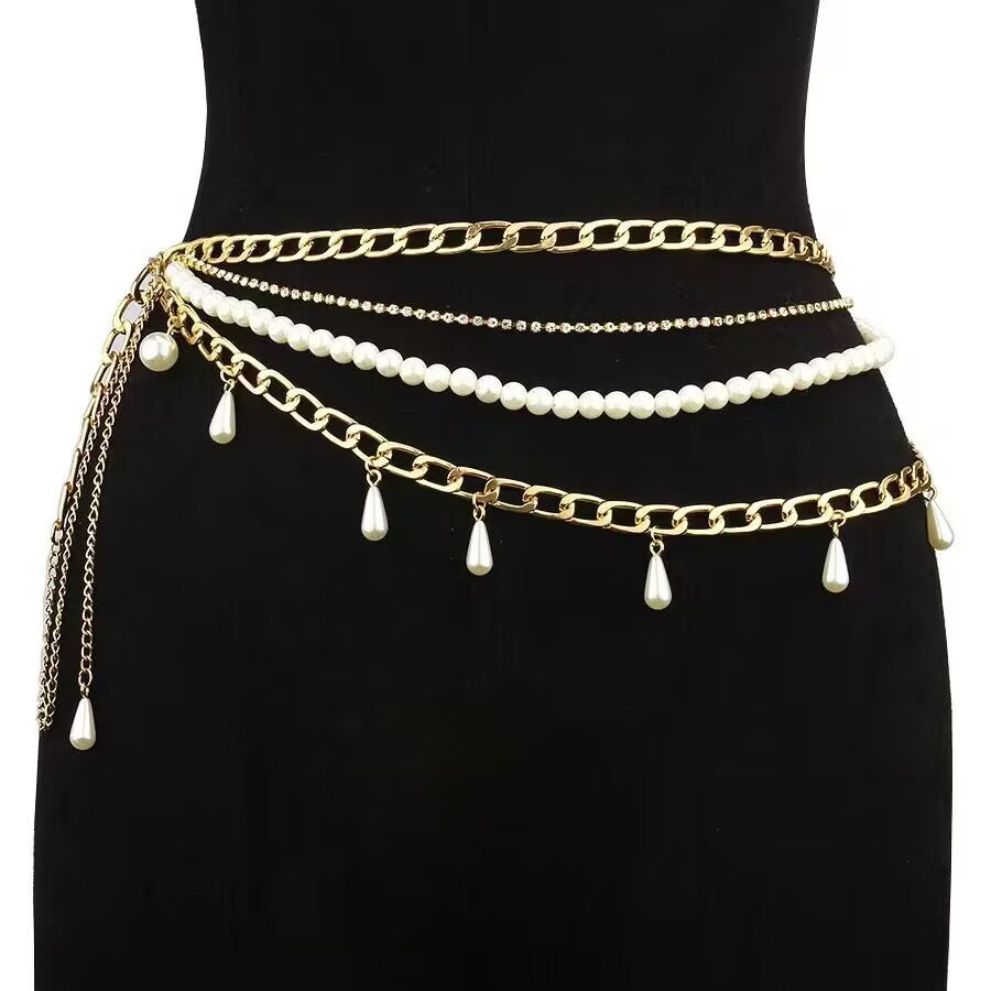Luxury gold multi layer pearl waist chain with cascading teardrop pearl tassels styled on a black dress mannequin, showcasing premium high-street rave accessory look.