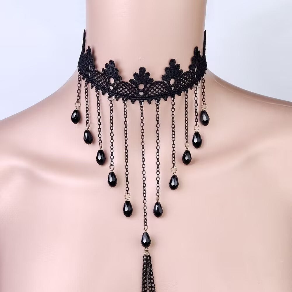 Close up shot of a high quality black lace choker with multiple hanging crystal beads and descending chest chains.