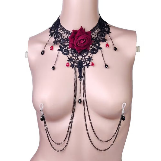 Close up of a black lace choker body chain featuring a large red rose and red teardrop beads with attached fake piercing chains.