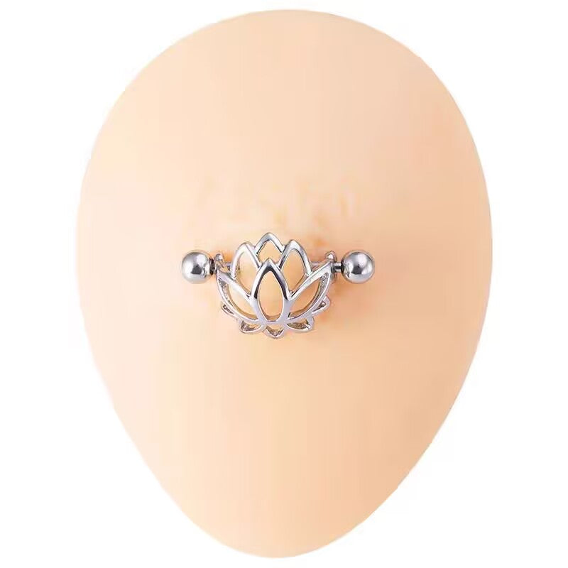 Close-up view of a lotus flower nipple shield piercing on a skin-tone silicone model for realistic sizing and fit.