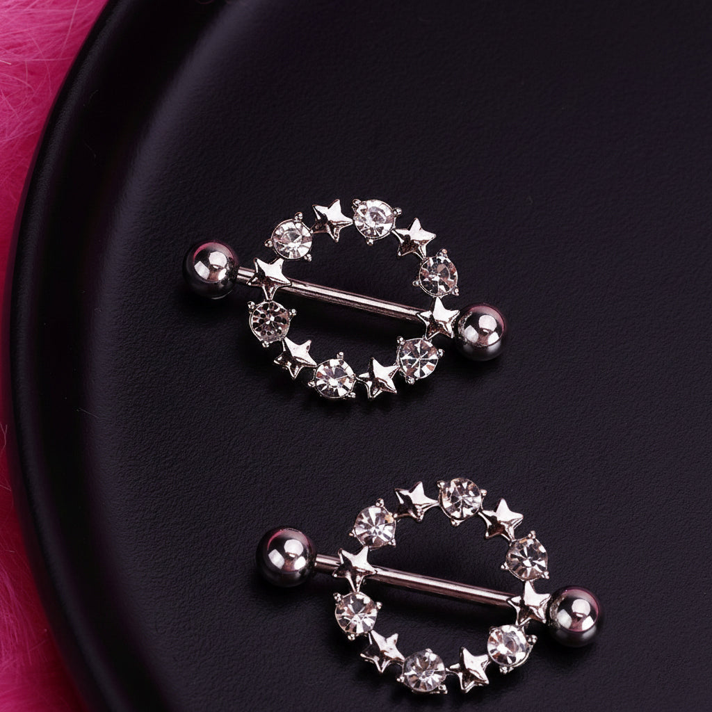 Two crystal star nipple shields displayed on a luxury dark aesthetic background