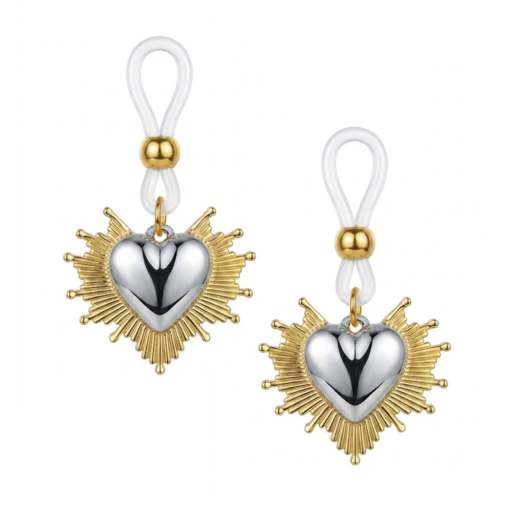A pair of alternative gothic sacred heart fake nipple piercing jewelry pieces with radiating gold sunburst aura and silver hearts on a pure white background.