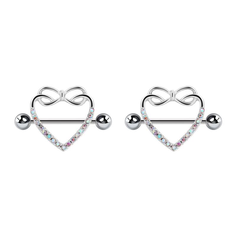 A pair of matching silver heart nipple shields with delicate bow accents and sparkling iridescent crystals set against a clean white background.