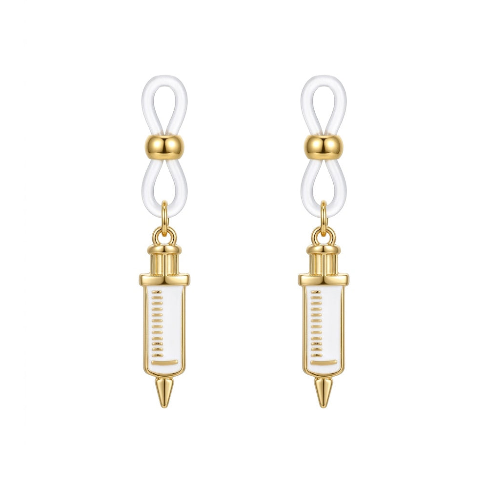 One matching pair of non-piercing fake nipple rings with white and gold medical syringe charms and secure clear silicone loops for adult bedroom roleplay.