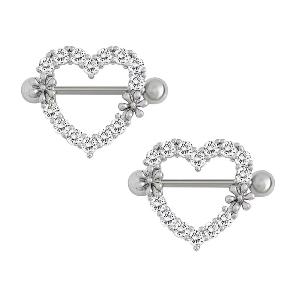 A matching pair of silver crystal heart nipple shields with barbell piercing studs, displaying a romantic alternative fashion style for coquette and gothic aesthetic lovers.