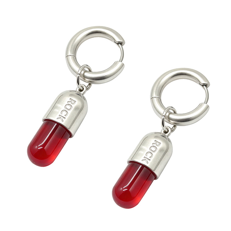 Pair of red pill dangle hoop earrings featuring translucent red capsule drops on a pure white background