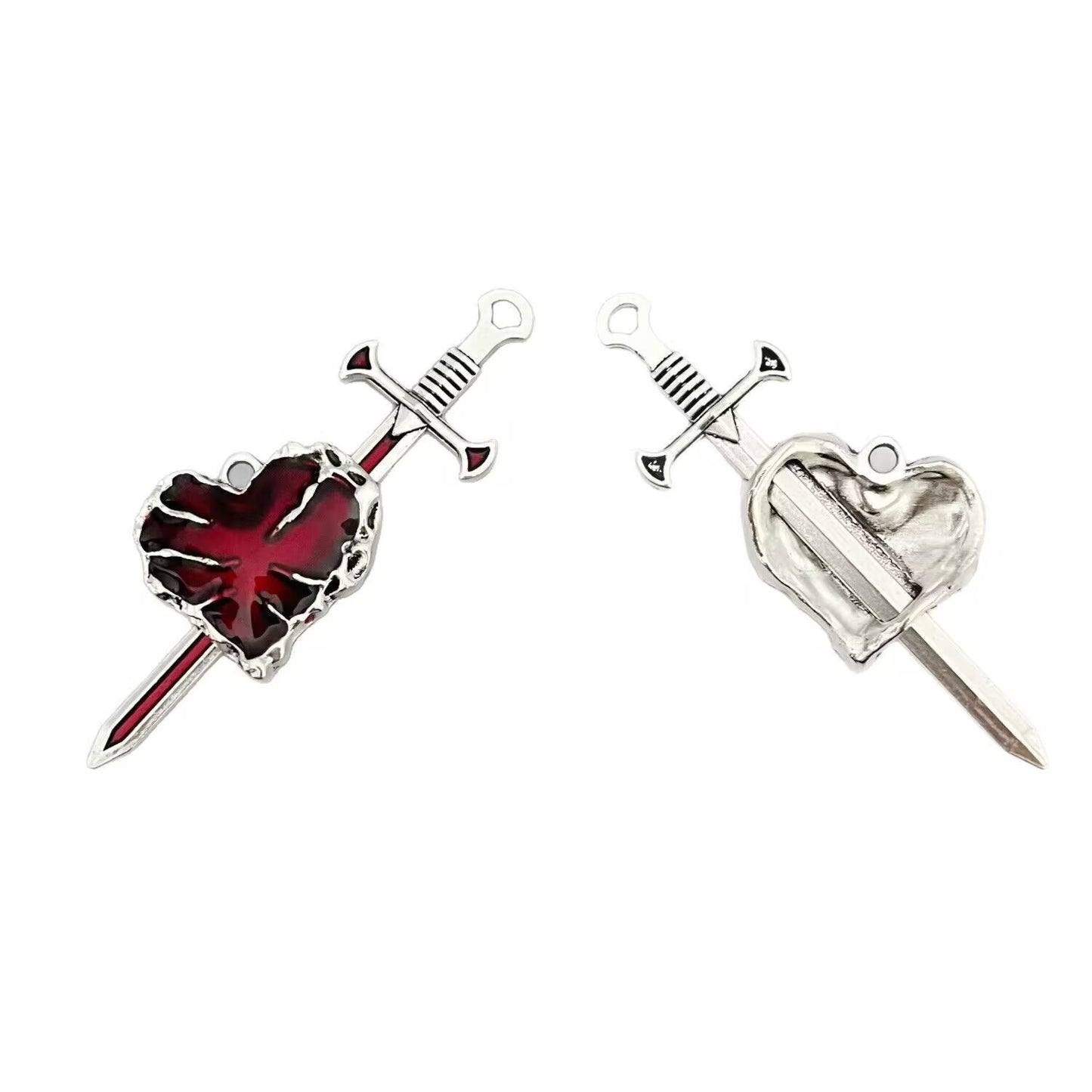 Detailed view of the gothic heart being pierced by the sword pendant, showcasing the intricate design and red enamel finish.