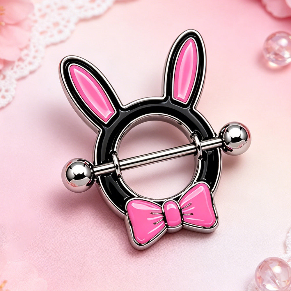 Aesthetic close-up of a pink bunny ear nipple ring on a soft pink decorative background