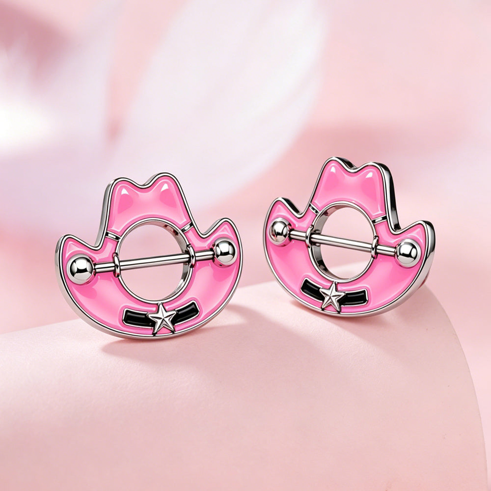 Close up of two pink cowboy hat nipple shields placed on a soft pink surface for aesthetic display.