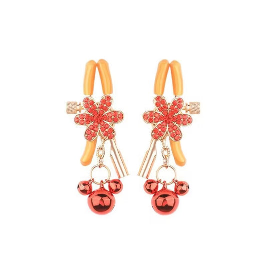 A pair of adjustable red rhinestone floral sensory clamps with bells.
