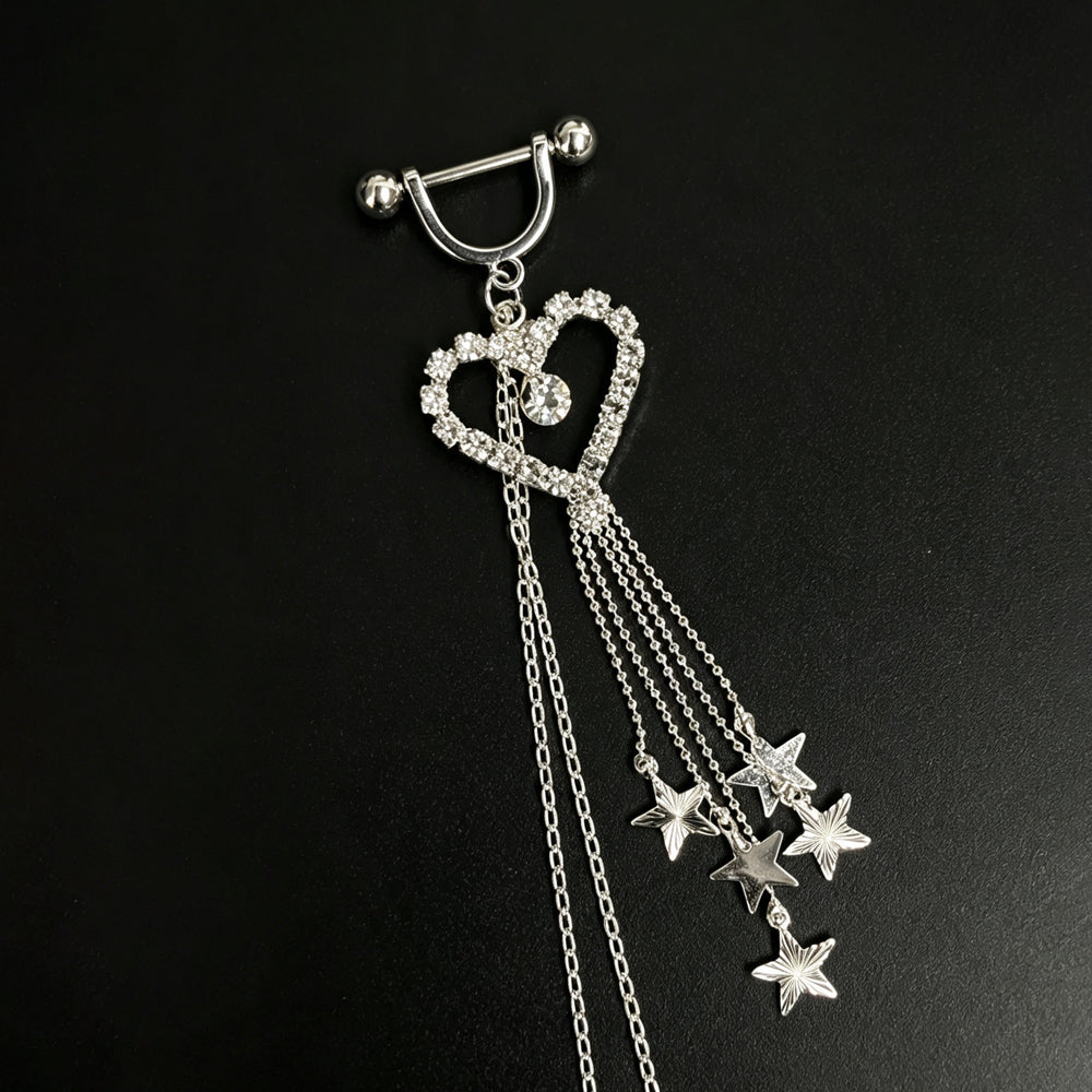 Detailed view of a single barbell nipple ring with a U-shaped shield, crystal heart pendant, and star charm tassel.