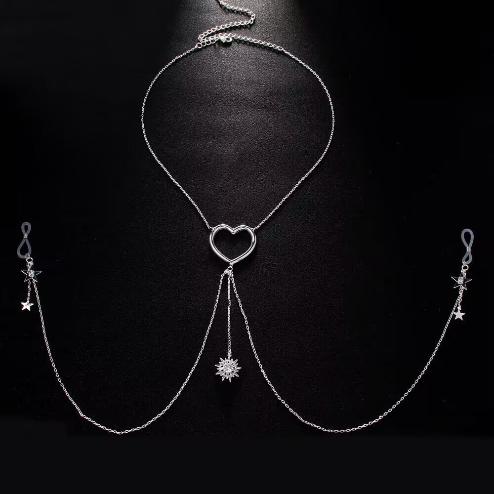 A silver-plated fake nipple piercing jewelry body chain set with adjustable silicone loops, star tassels, and an open-heart necklace layout flat on a black background.
