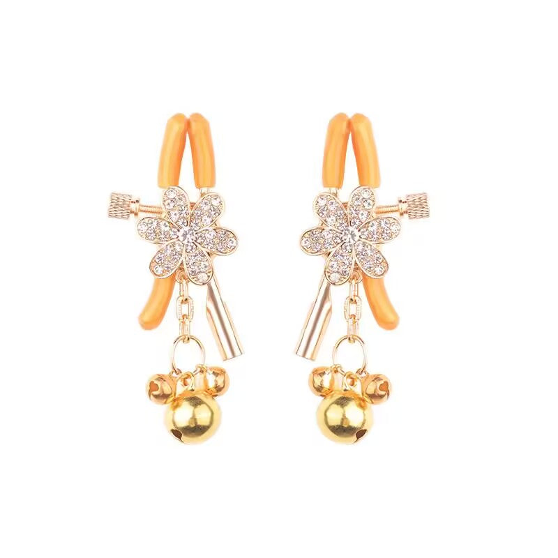 A pair of adjustable silver rhinestone floral sensory clamps with gold bells.