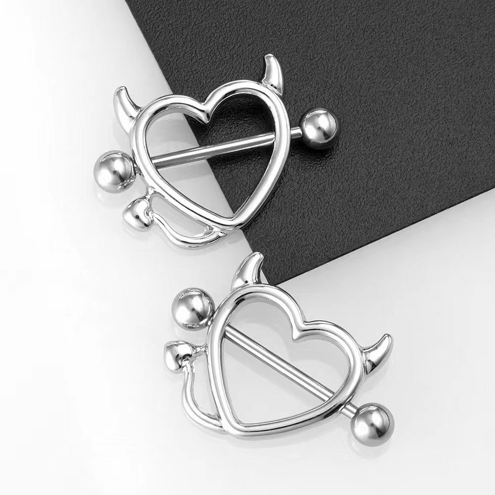 Elegant heart-shaped nipple piercing jewelry with devil theme aesthetic.