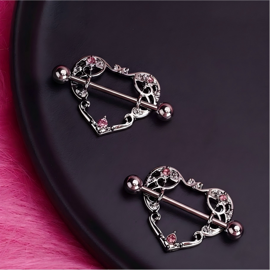 Intricate silver-tone heart-shaped nipple shield jewelry featuring pink rhinestone accents and a straight barbell.-1