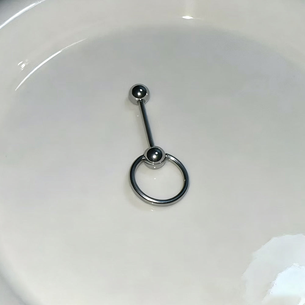 High-polish silver-toned surgical steel straight barbell with an attached slave O-ring, photographed on a clean white surface.
