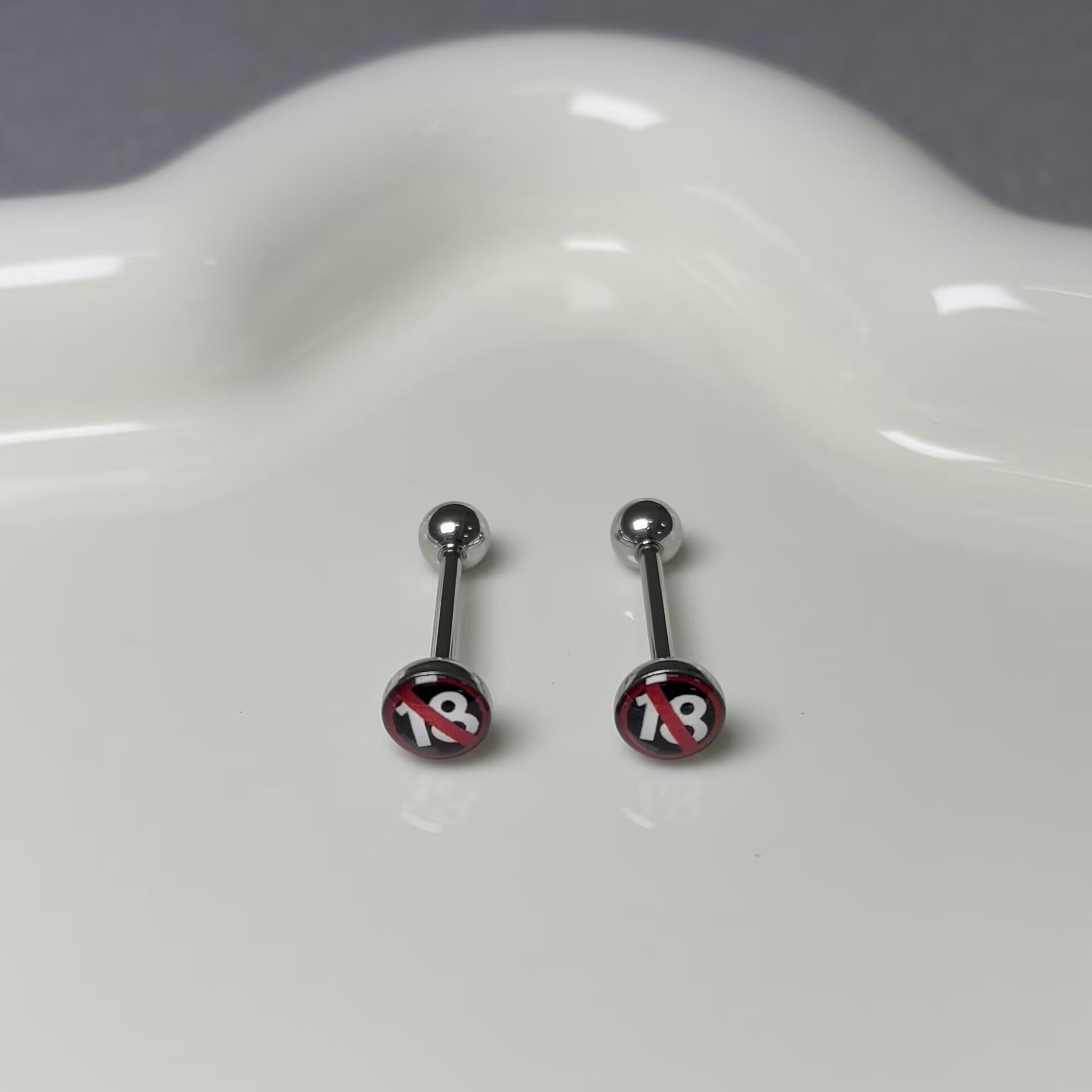 Pair of 18+ logo flat top tongue barbells on a clean white display background.