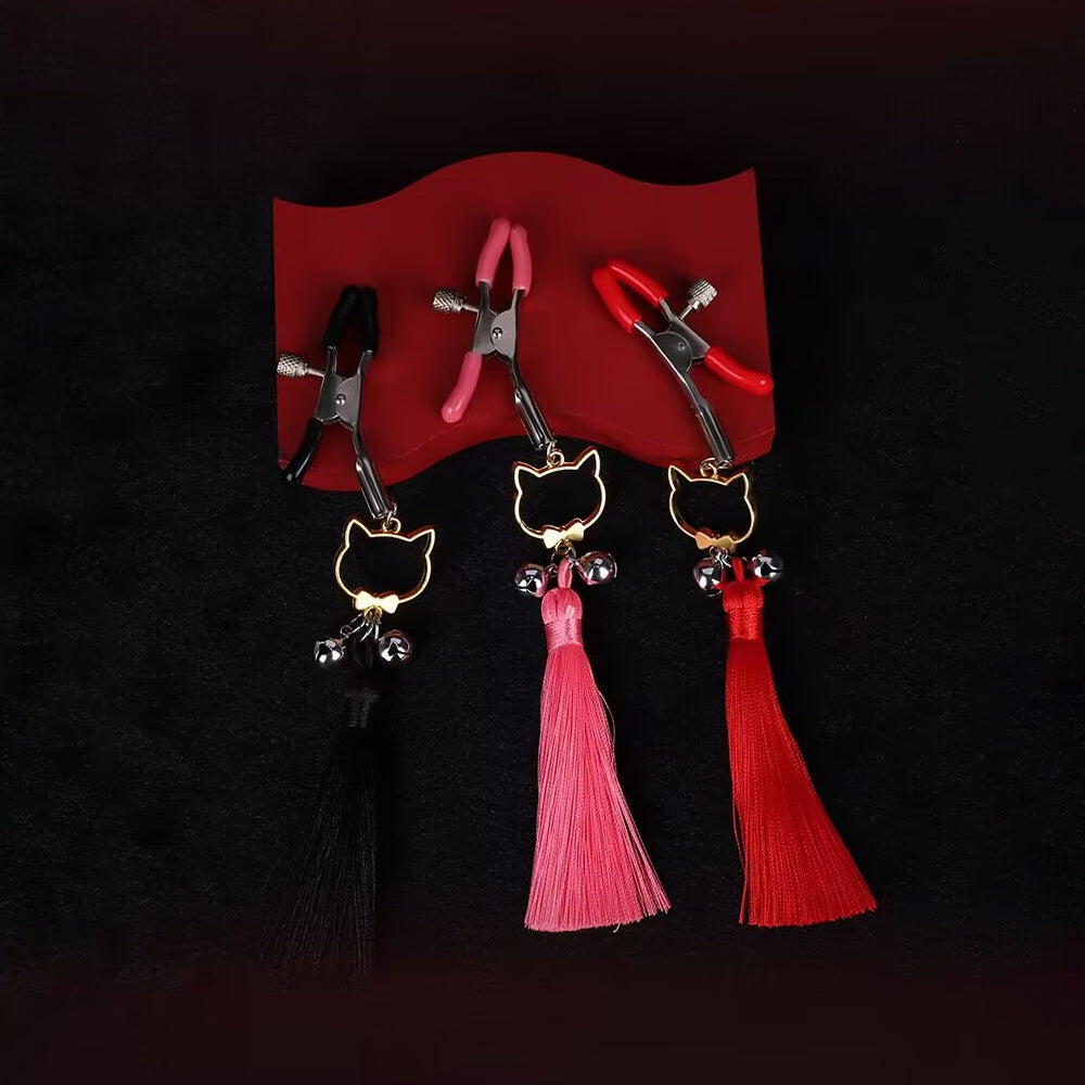 A set of three adjustable body clamps in black, pink, and red on a dark background.