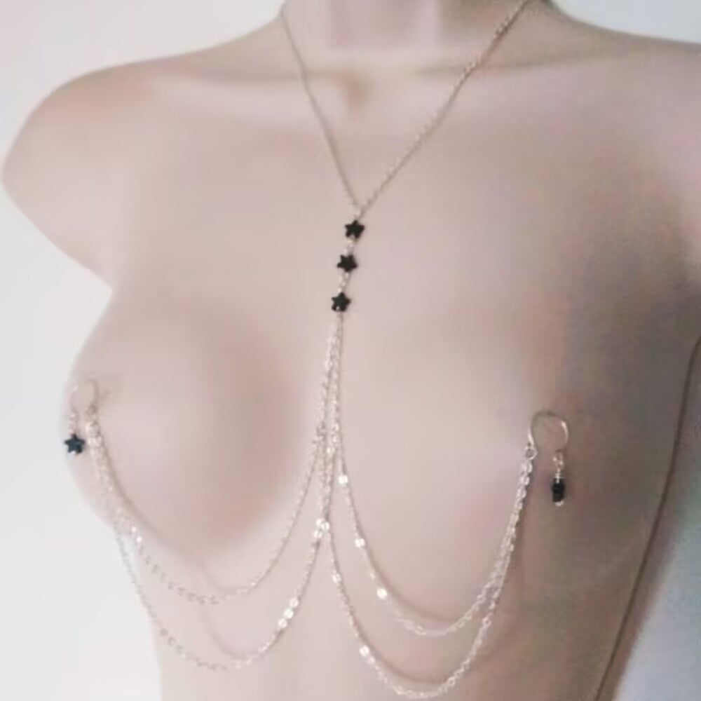 Close up of adjustable lobster claw clasp on chest chain body jewelry.