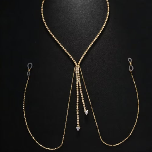 Flat lay product display of a gold rhinestone non-piercing nipple chain body jewelry on a black background, showing the adjustable transparent silicone loops and rhinestone drop pendants.