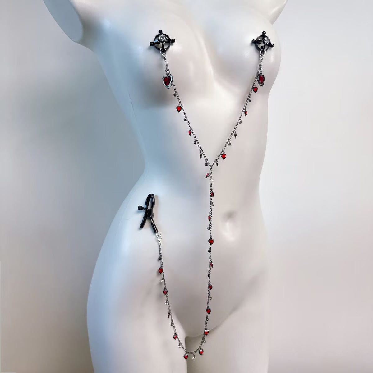 Adjustable non-pierced nipple clamps with red heart crystal hanging body chain on female form