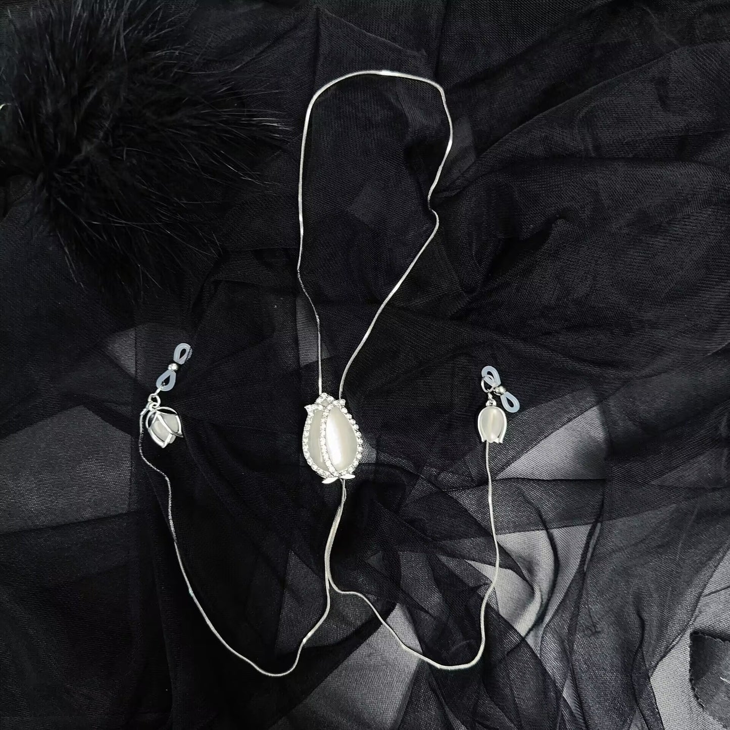 Flat lay overview of the adjustable non-pierced nipple clamp necklace with soft rubber loops.