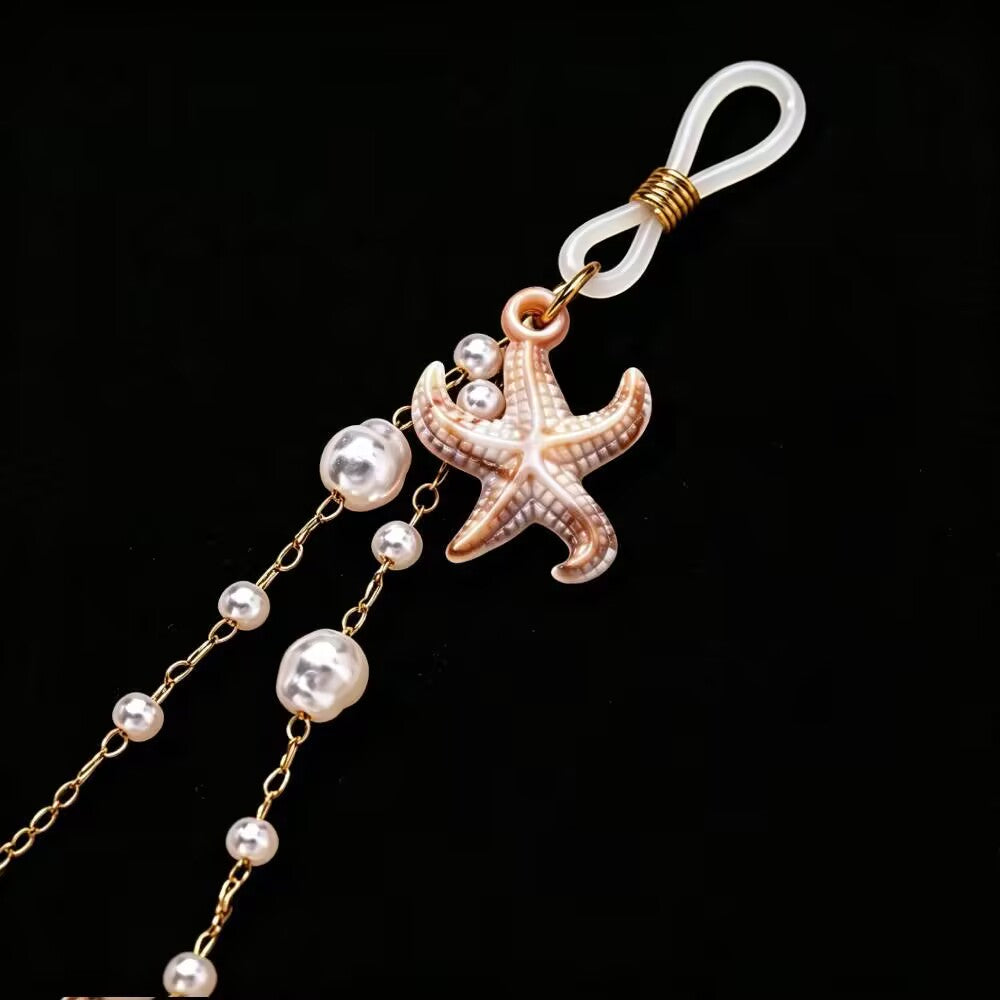 Close-up detail of clear adjustable silicone loop nipple clamp with resin starfish and pearl dangle