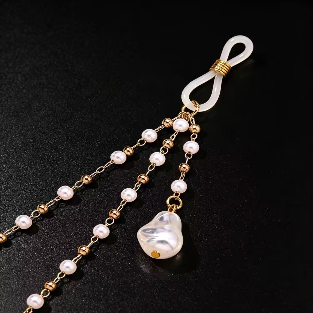Close up detail of adjustable clear silicone loop and baroque pearl drop on nipple clamp jewelry