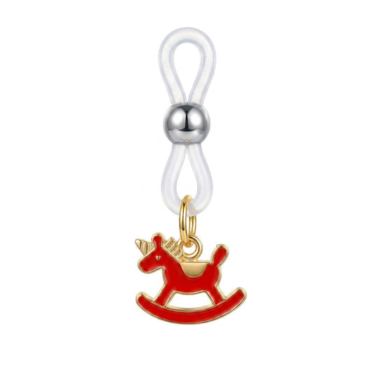 Close-up of a single non-piercing body clamp with a transparent silicone loop and a red rocking horse pendant.