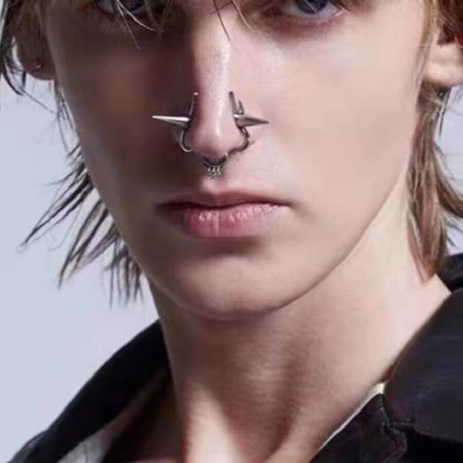 Model styled in alternative goth jewelry featuring a silver-tone double nose cuff with cones