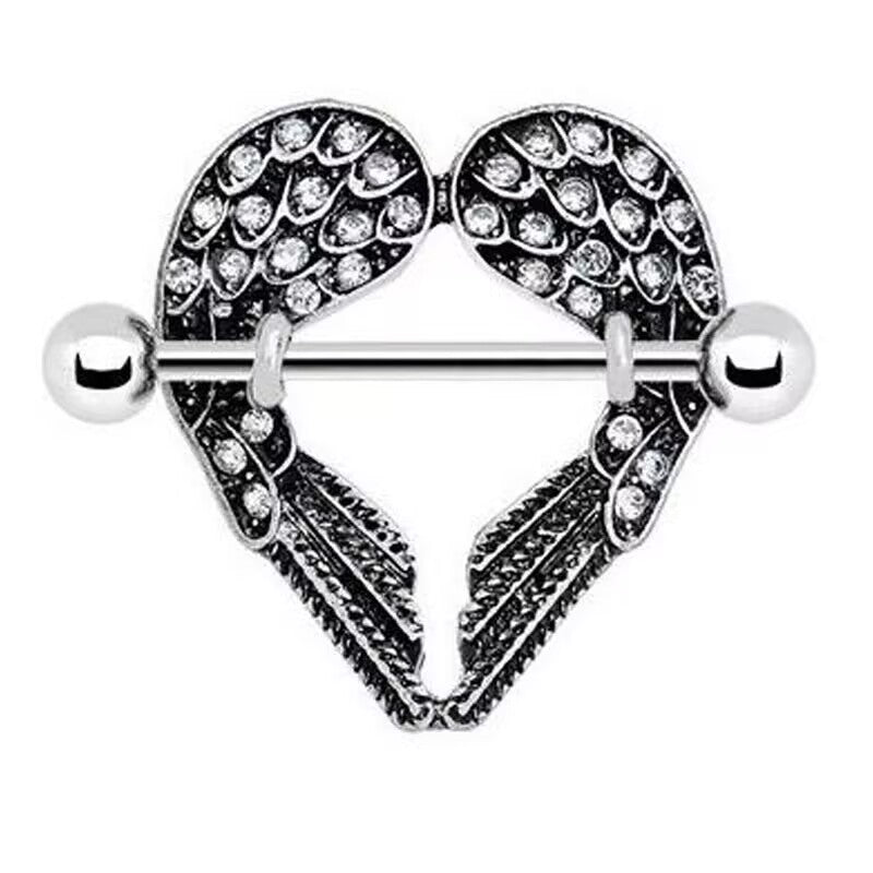 Close-up view of a silver heart-shaped nipple shield featuring crystal-studded angel wings and a straight barbell.