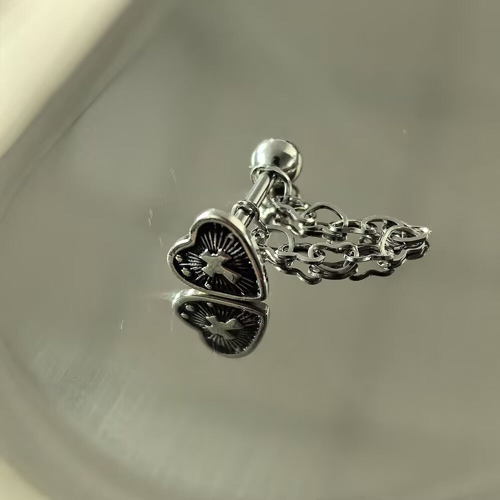 Antique silver gothic heart cross tongue ring featuring a delicate heart link chain on a reflective background.