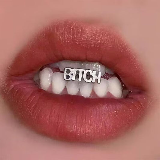 Silver BITCH letter tongue ring displayed inside mouth on a healed tongue piercing.