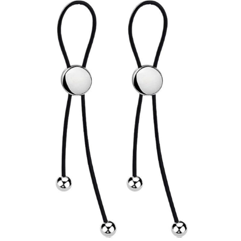 Pair of black nipple clips with looped straps, round silver-tone fronts and smooth bead pendants on white.