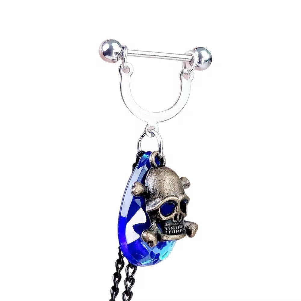 Blue crystal teardrop nipple ring with antique gold skull overlay and hanging chain.