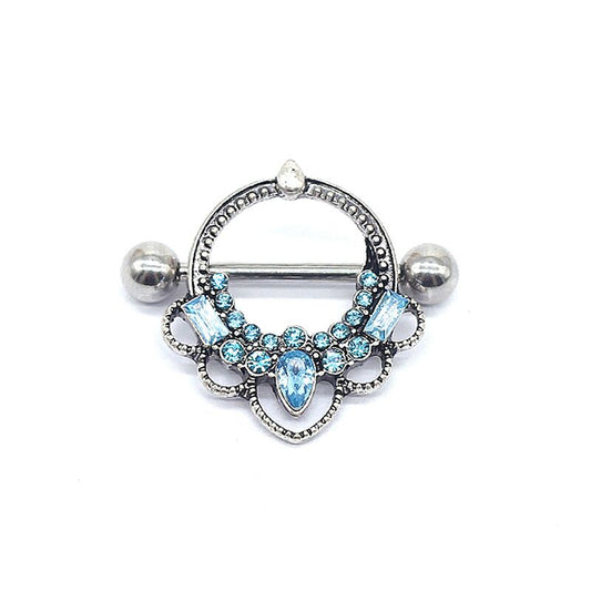 Detailed front view of a vintage crown nipple shield with light blue crystals on a white background.