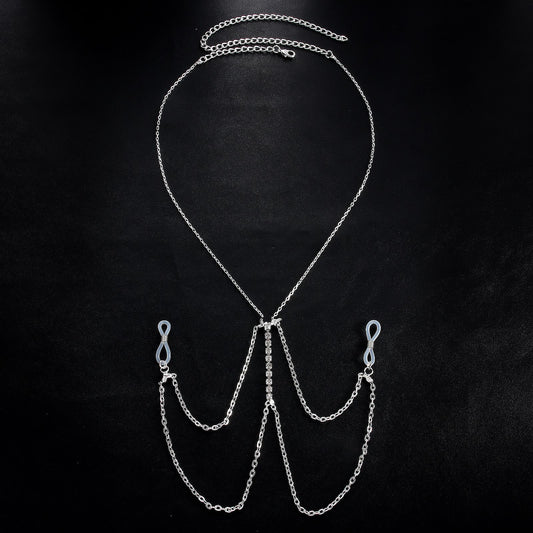 Exquisite multilayer tassel body chain with crystal centerpiece displayed on a black background.