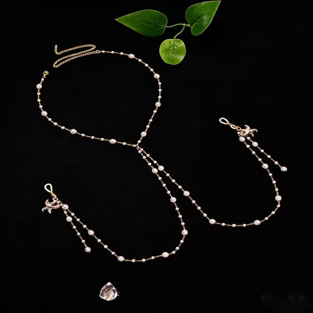 Bohemian style starfish pearl breast chain and faux nipple ring body jewelry on dark background