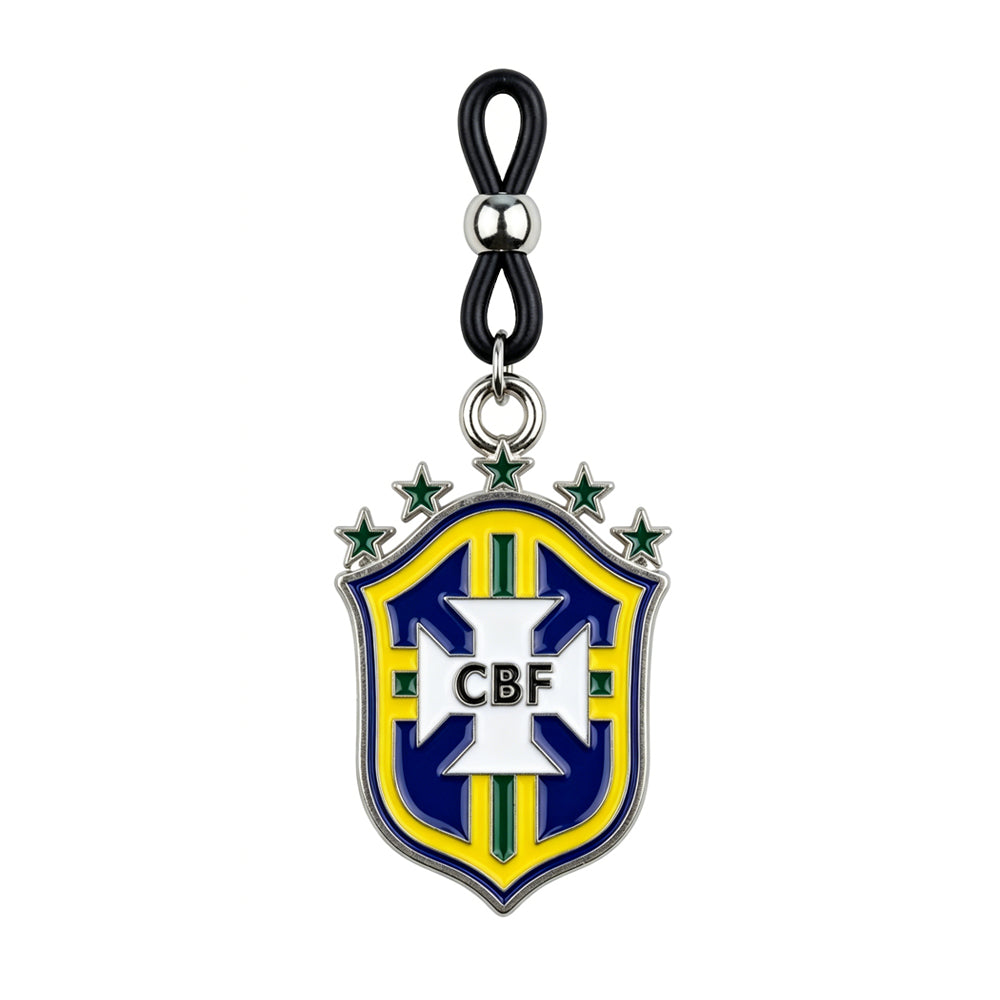 Detailed view of a non-piercing nipple clamp featuring a yellow and blue Brazil soccer crest pendant with an adjustable black loop on a pure white background.