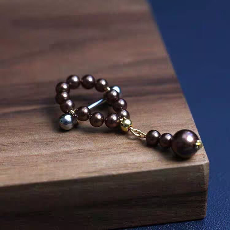 Bronze brown pearl dangle nipple barbell featuring a pearl teardrop pendant.