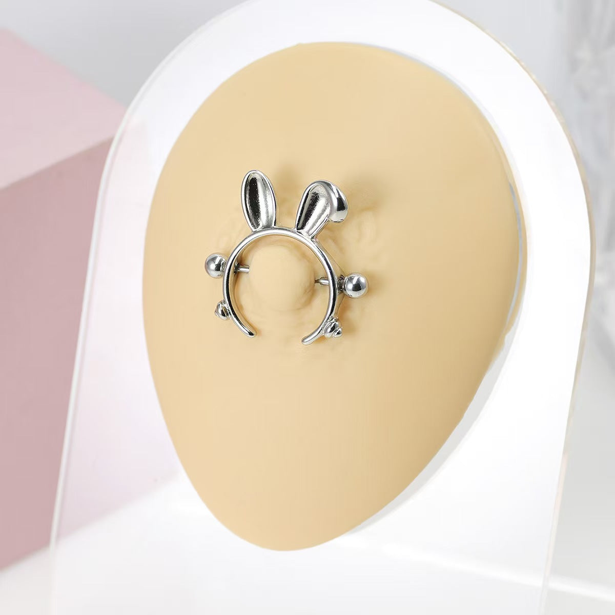 Bunny ears nipple shield jewelry shown on a professional model display for scale and fit.
